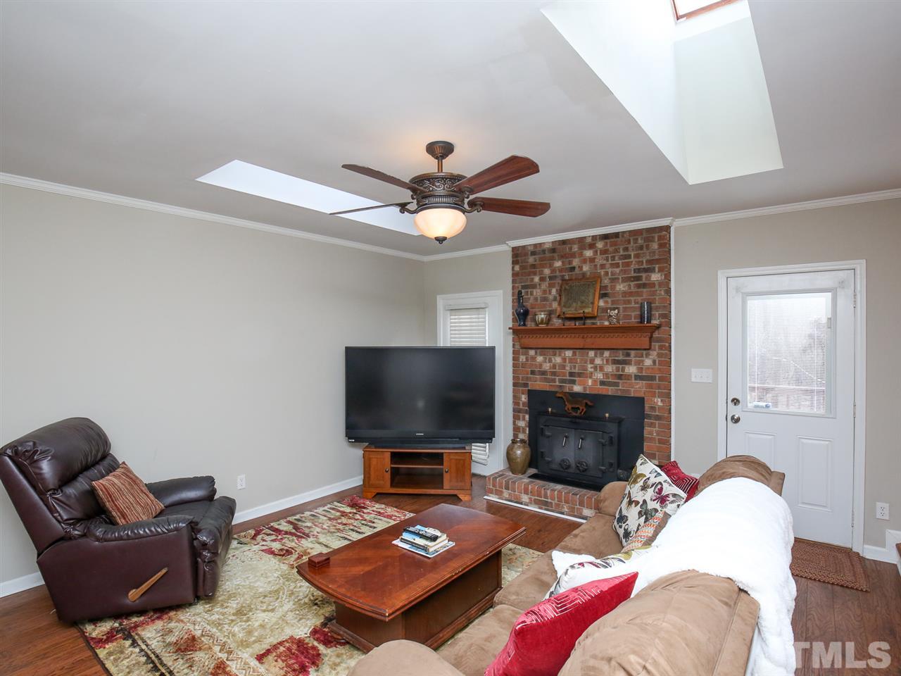 1811 Southview Road Durham, NC 27703 - Photo 5 of 30 a living room with furniture a fireplace and a flat screen tv