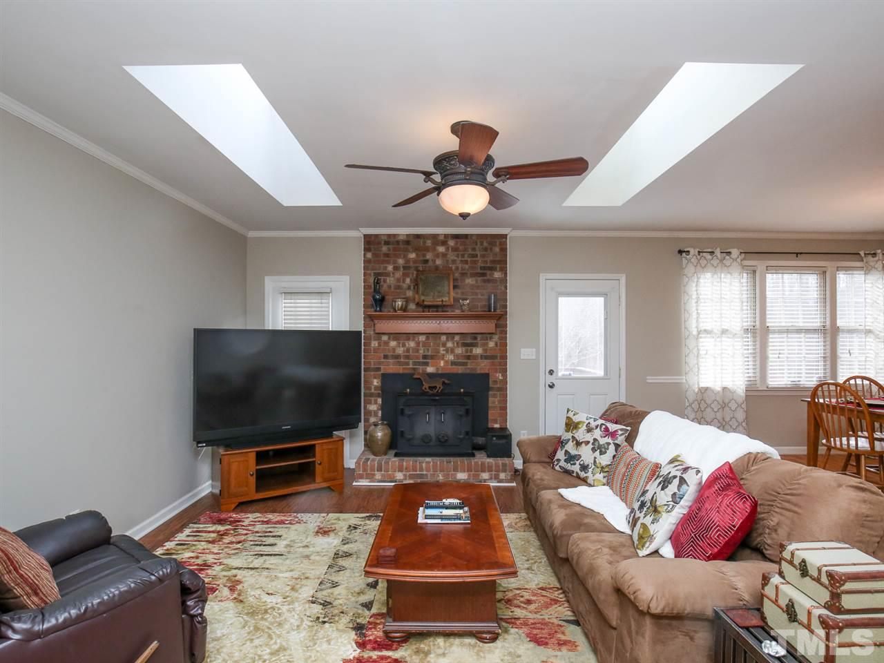1811 Southview Road Durham, NC 27703 - Photo 7 of 30 a living room with furniture a flat screen tv and a fireplace