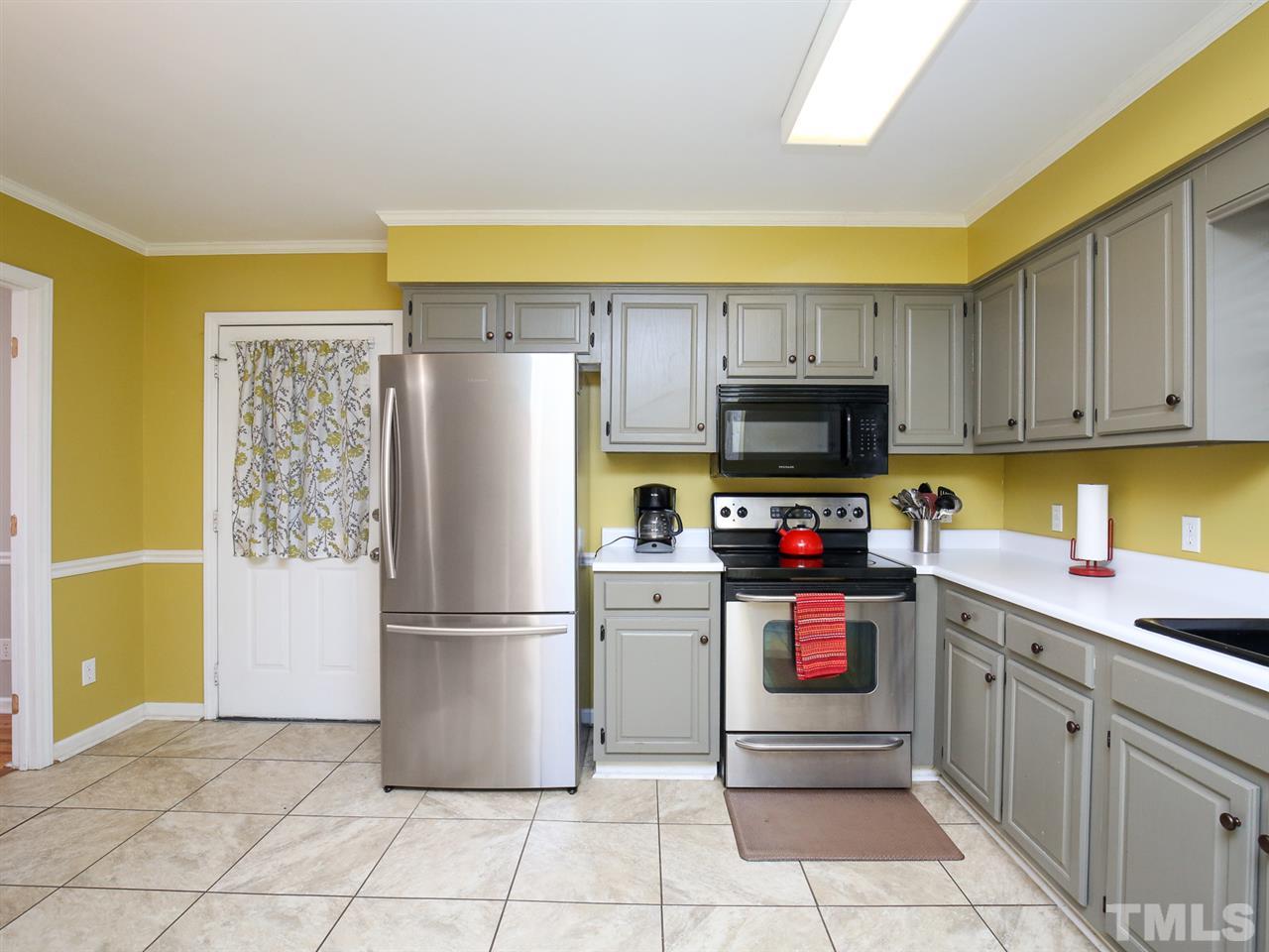 1811 Southview Road Durham, NC 27703 - Photo 10 of 30 a kitchen with stainless steel appliances granite countertop a refrigerator and a stove top oven