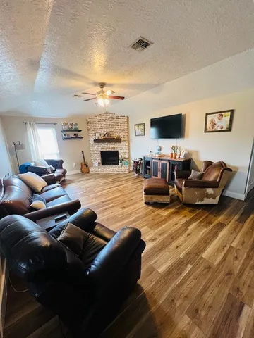 a living room with furniture fireplace and a flat screen tv