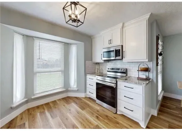 a kitchen with a stove oven and a sink