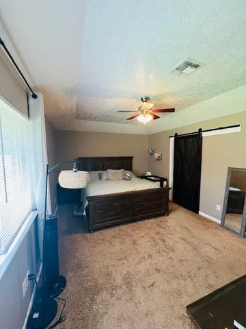 a bedroom with a bed and a table