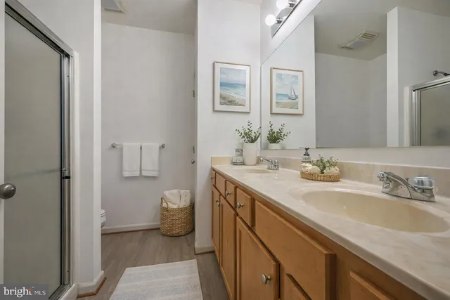 a spacious bathroom with a granite countertop sink and a mirror