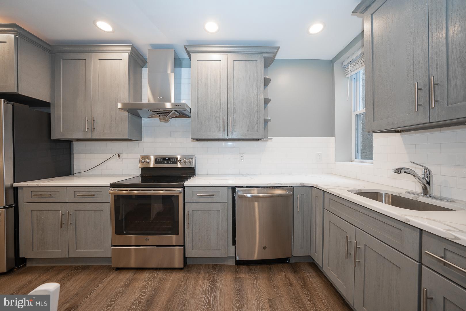 524 South 3rd Street Philadelphia, PA 19147 - Photo 8 of 22 a kitchen with stainless steel appliances granite countertop a sink stove and refrigerator