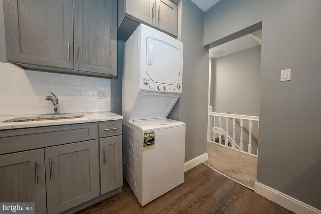 a utility room with cabinets washer and dryer