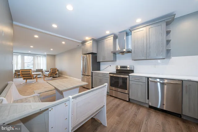 a kitchen with sink refrigerator and microwave
