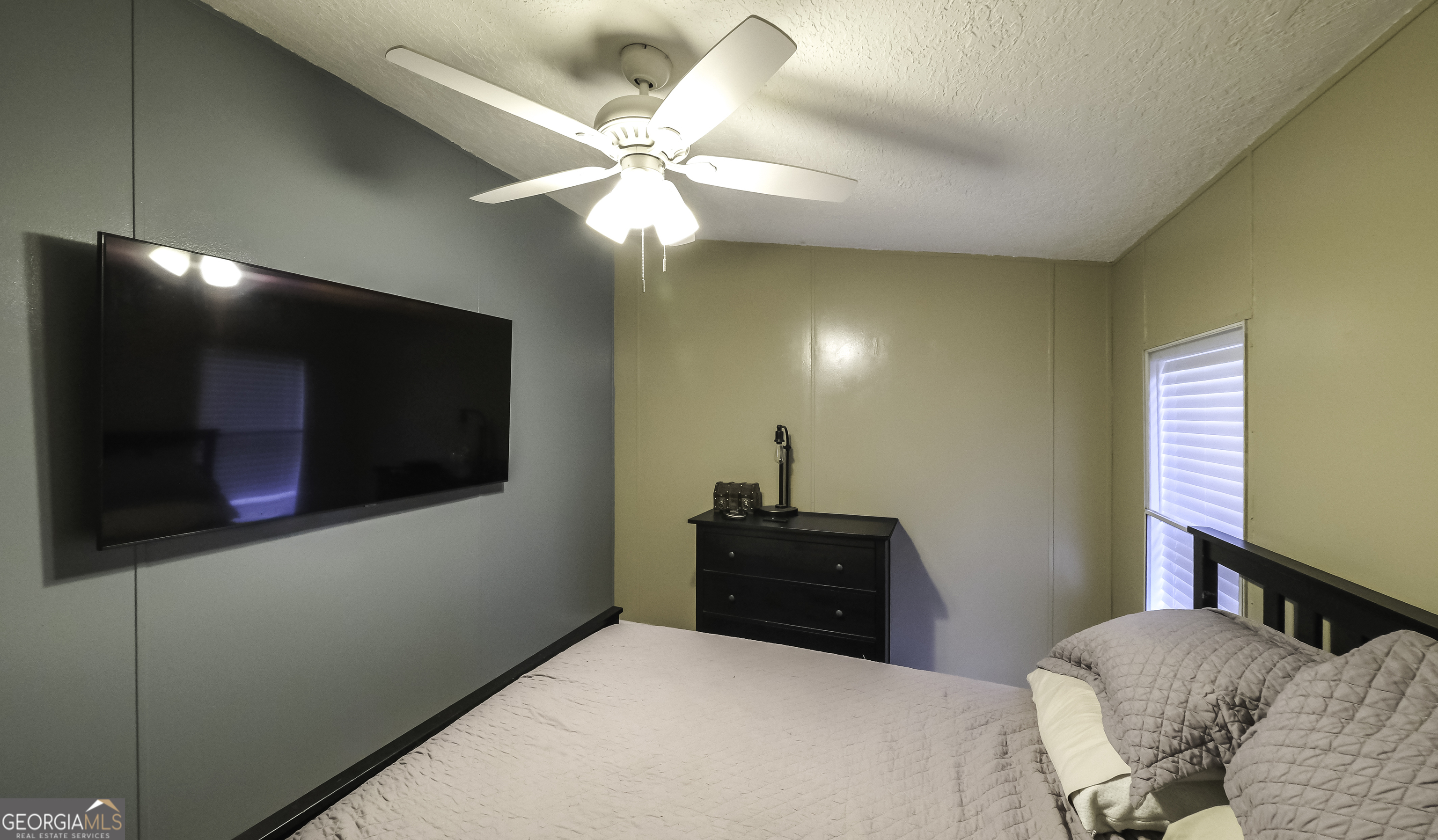 91 Holder Road Temple, GA 30179 - Photo 30 of 40 a bedroom with a bed and a flat screen tv