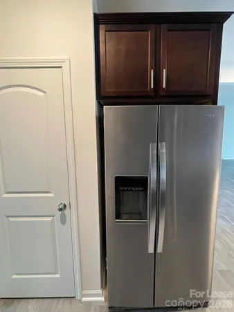 a large kitchen with a stove a refrigerator and a sink