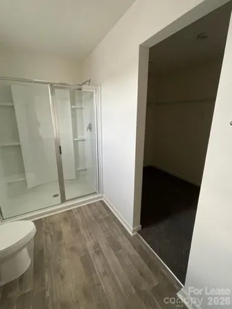 a bathroom with a double vanity sink a toilet and mirror