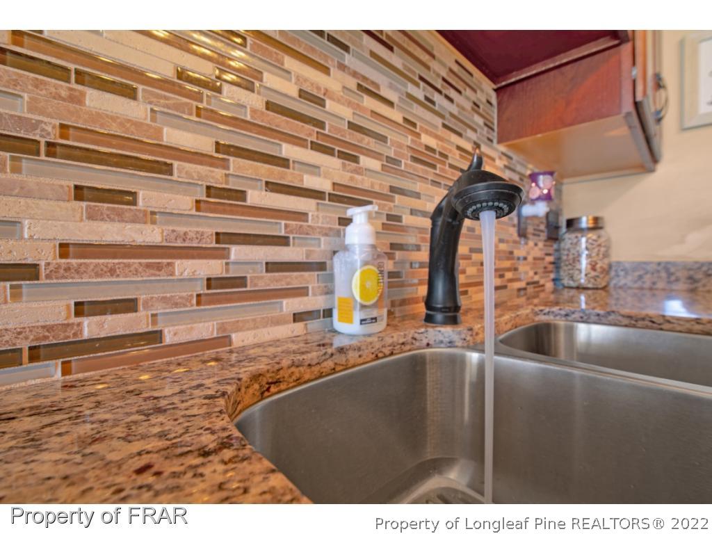 361 Camden Road Raeford, NC 28376 - Photo 14 of 36 a kitchen with a sink and a wooden floor