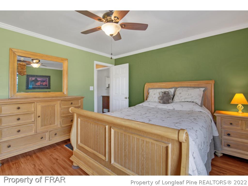 361 Camden Road Raeford, NC 28376 - Photo 19 of 36 a bedroom with a bed and a dresser