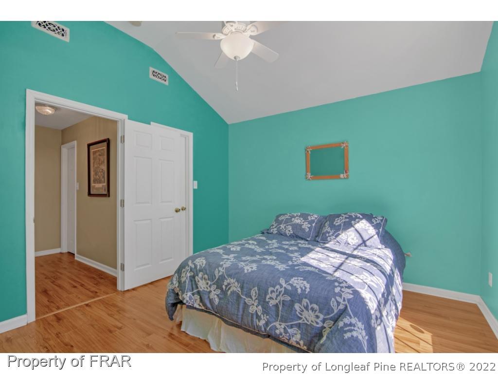 361 Camden Road Raeford, NC 28376 - Photo 24 of 36 a bedroom with a bed and a painting on the wall