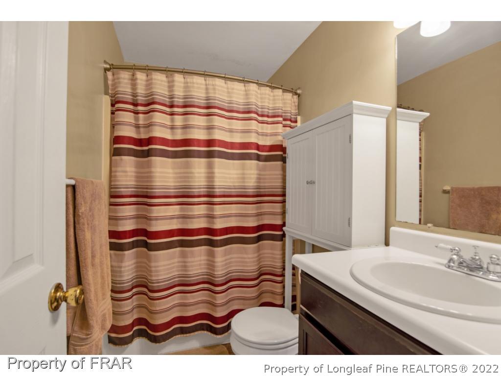 361 Camden Road Raeford, NC 28376 - Photo 27 of 36 a bathroom with a sink and a mirror