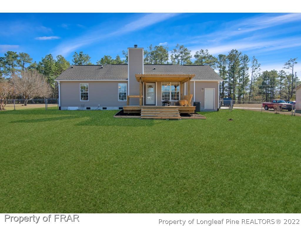 361 Camden Road Raeford, NC 28376 - Photo 30 of 36 a view of a house with a yard and sitting area