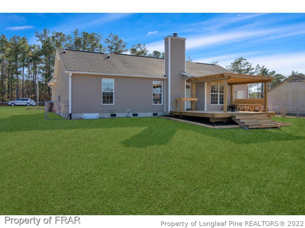 361 Camden Road Raeford, NC 28376 - Photo 31 of 36 a front view of a house with a garden and yard
