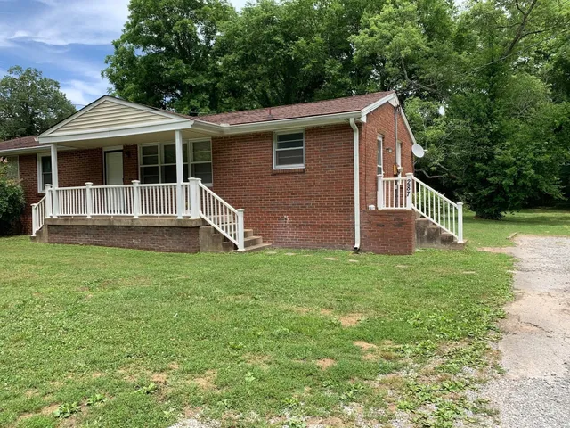 a front view of house with yard and green space