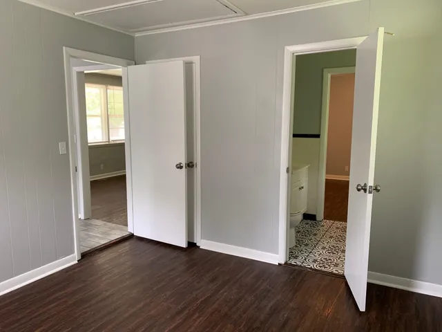 an empty room with wooden floor and a window