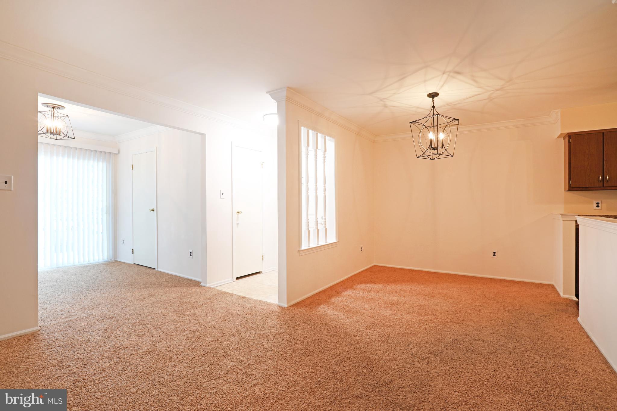 19 Chelsea Court Sewell, NJ 08080 - Photo 2 of 19 en empty room with windows and chandelier