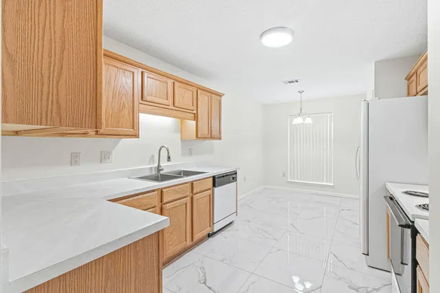 a kitchen with a sink stove and cabinets