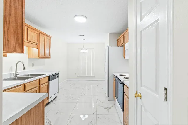 a bathroom with a sink a toilet a mirror and shower