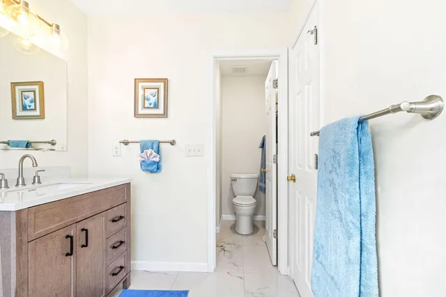 a spacious bathroom with a shower sink and toilet