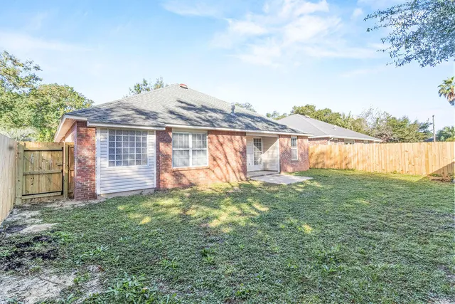 a backyard of a house with lots of green space and lake view