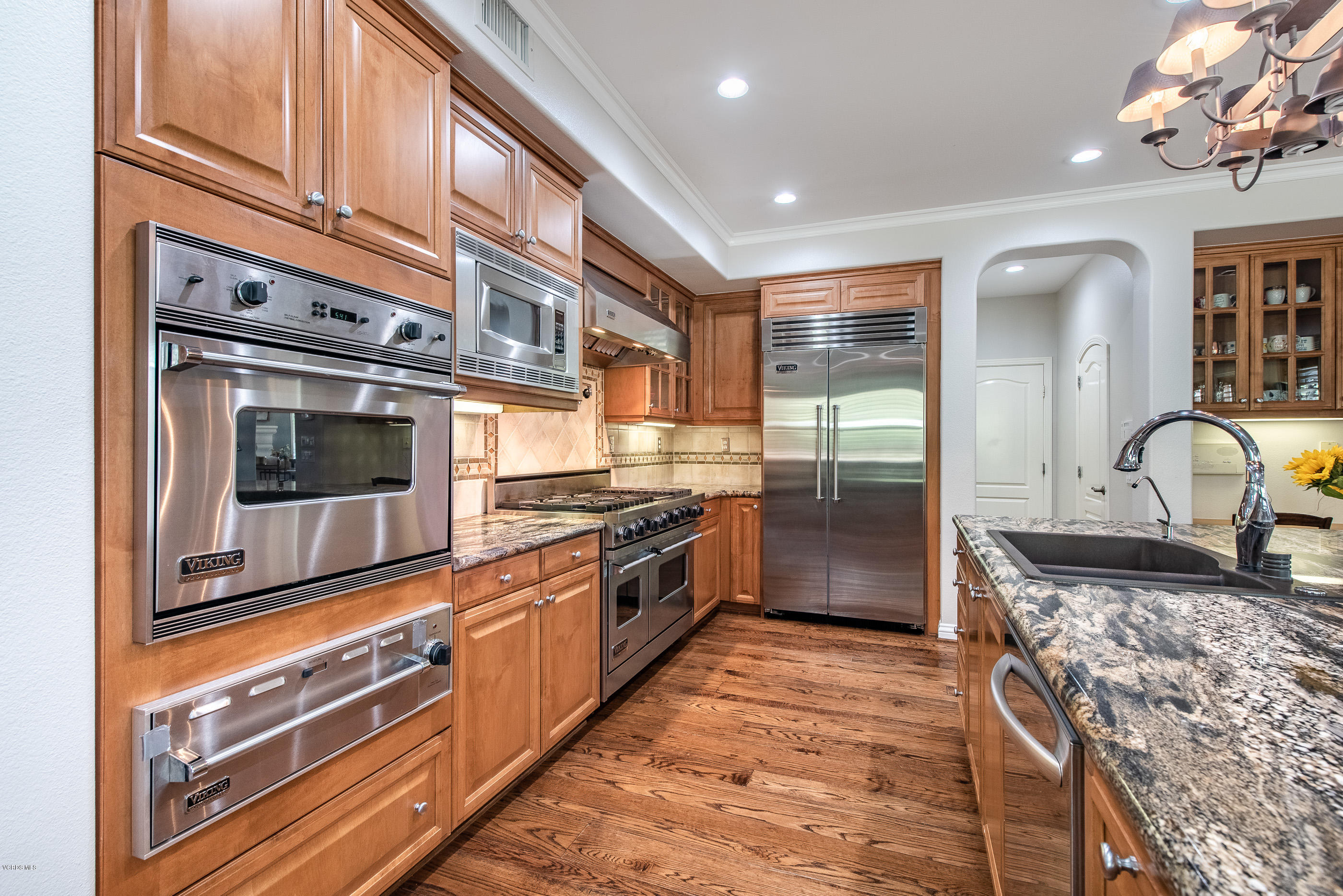 5635 Evening Sky Drive Simi Valley, CA 93063 - Photo 26 of 84 a kitchen with stainless steel appliances granite countertop a stove and a sink