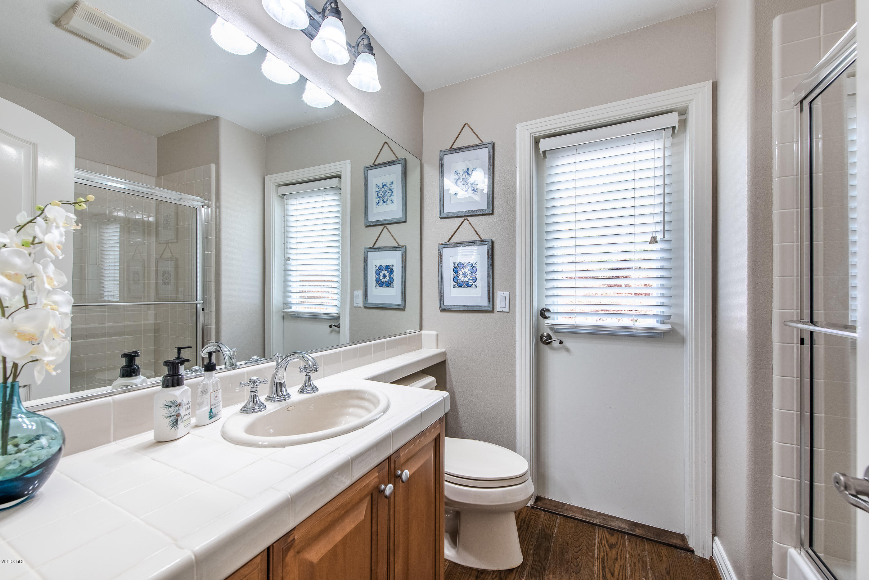 5635 Evening Sky Drive Simi Valley, CA 93063 - Photo 33 of 84 a bathroom with a sink a toilet and a mirror