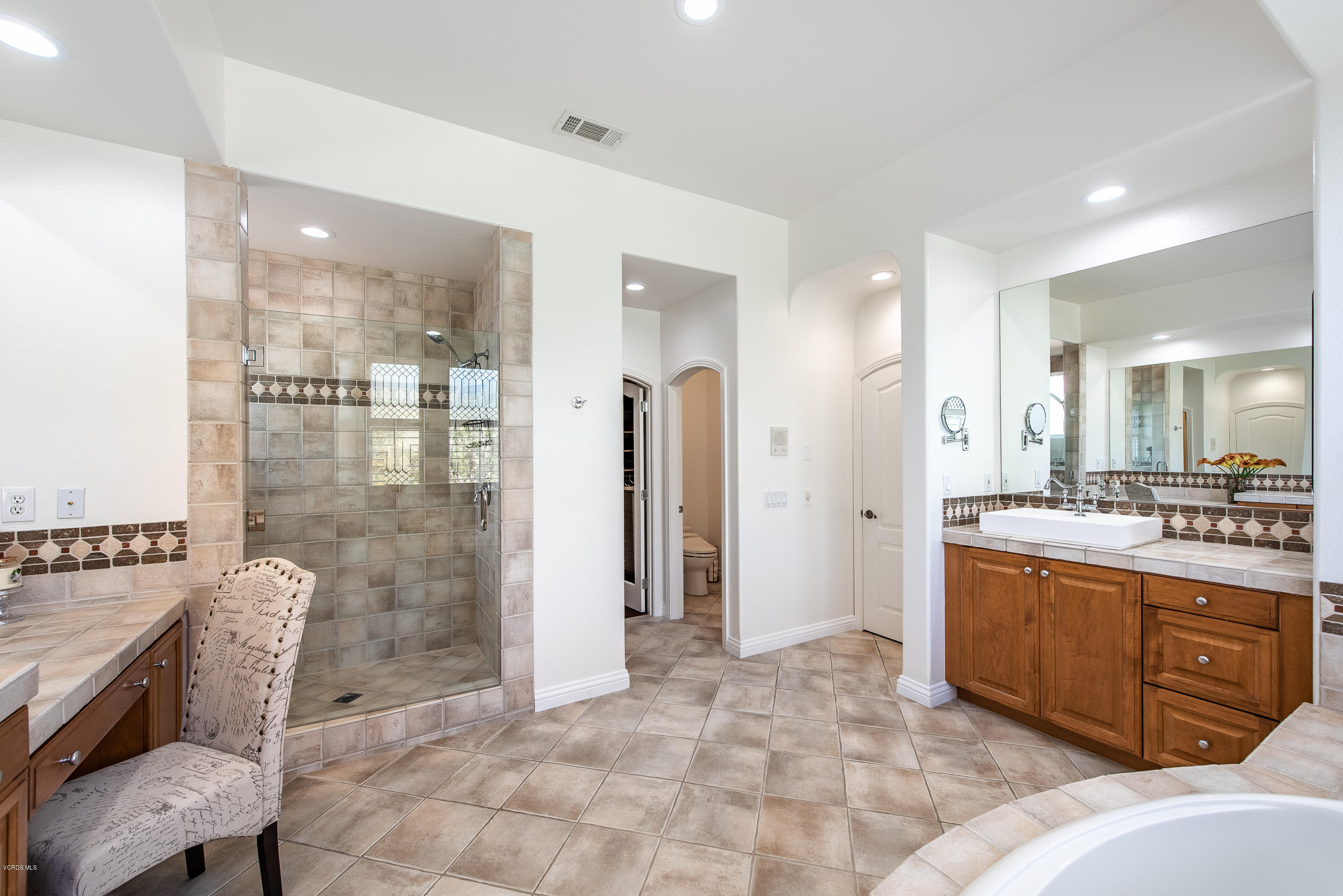 5635 Evening Sky Drive Simi Valley, CA 93063 - Photo 43 of 84 a large bathroom with a granite countertop sink a toilet a mirror and shower