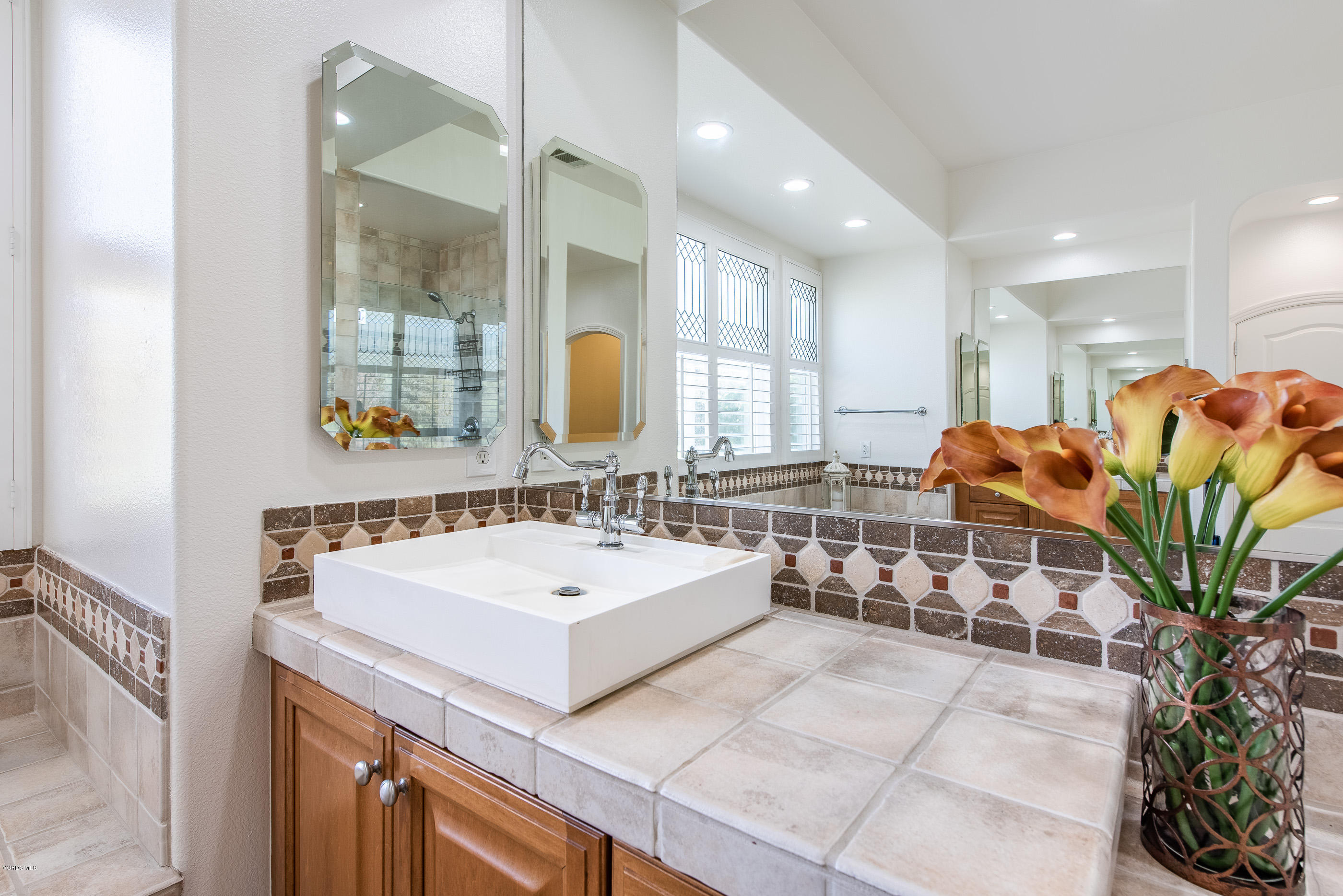 5635 Evening Sky Drive Simi Valley, CA 93063 - Photo 44 of 84 a bathroom with a sink and a mirror