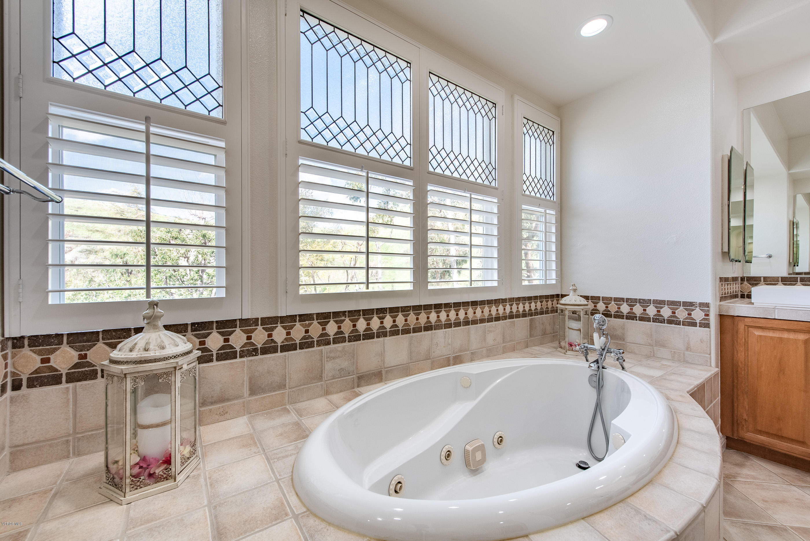 5635 Evening Sky Drive Simi Valley, CA 93063 - Photo 45 of 84 a bathroom with a bathtub and a window