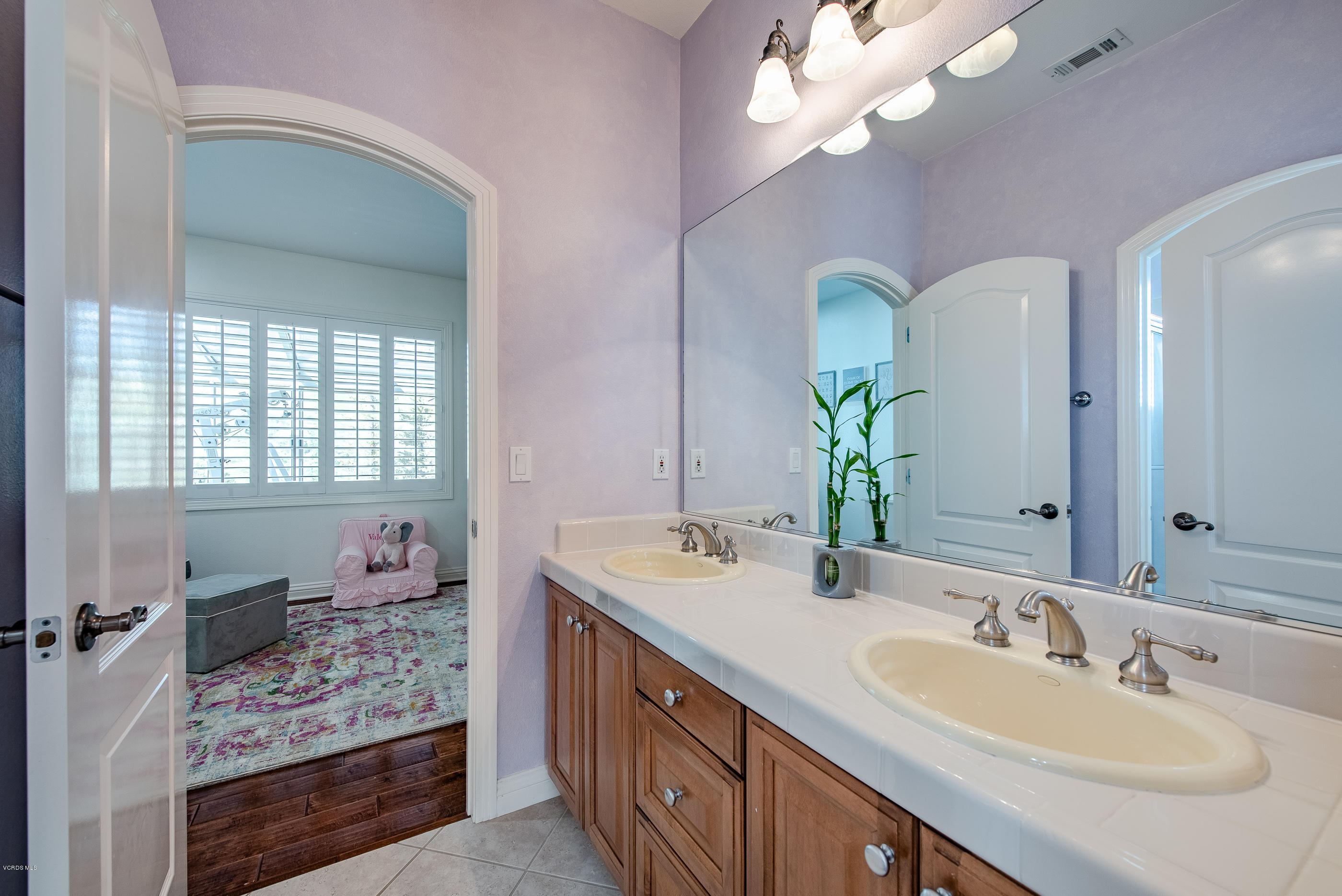 5635 Evening Sky Drive Simi Valley, CA 93063 - Photo 52 of 84 a bathroom with a sink a vanity and a mirror