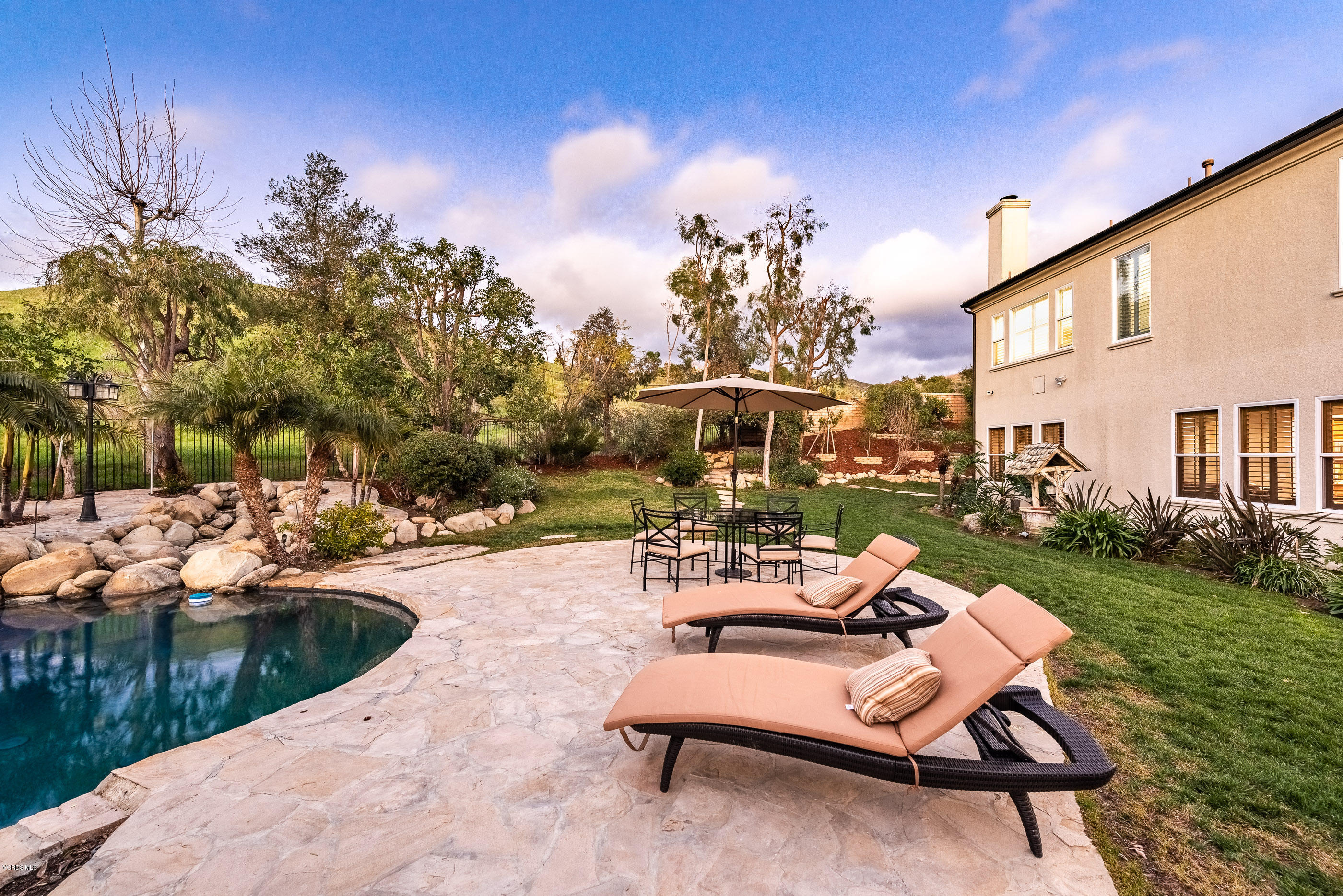 5635 Evening Sky Drive Simi Valley, CA 93063 - Photo 73 of 84 a view of a patio with couches table and chairs and potted plants