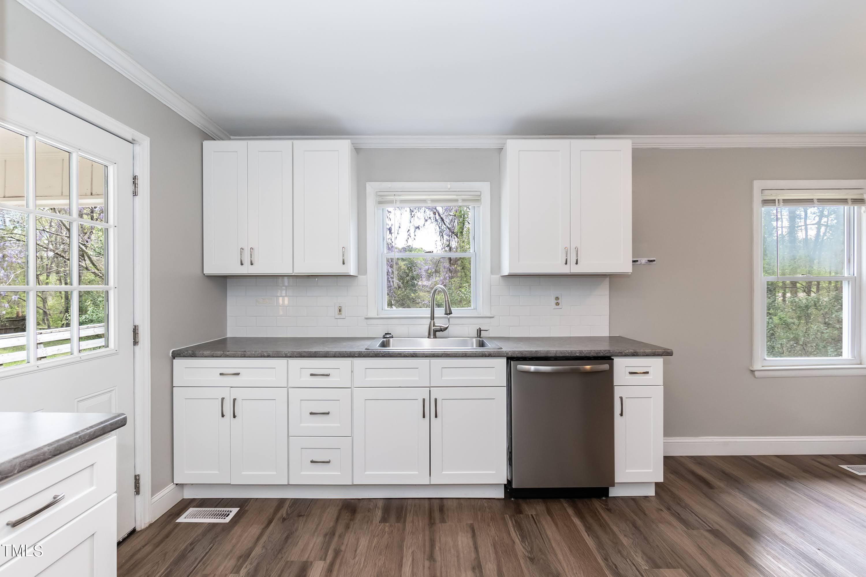 2019 Highway 55 Durham, NC 27707 - Photo 11 of 34 a kitchen with stainless steel appliances granite countertop a sink a stove and cabinets