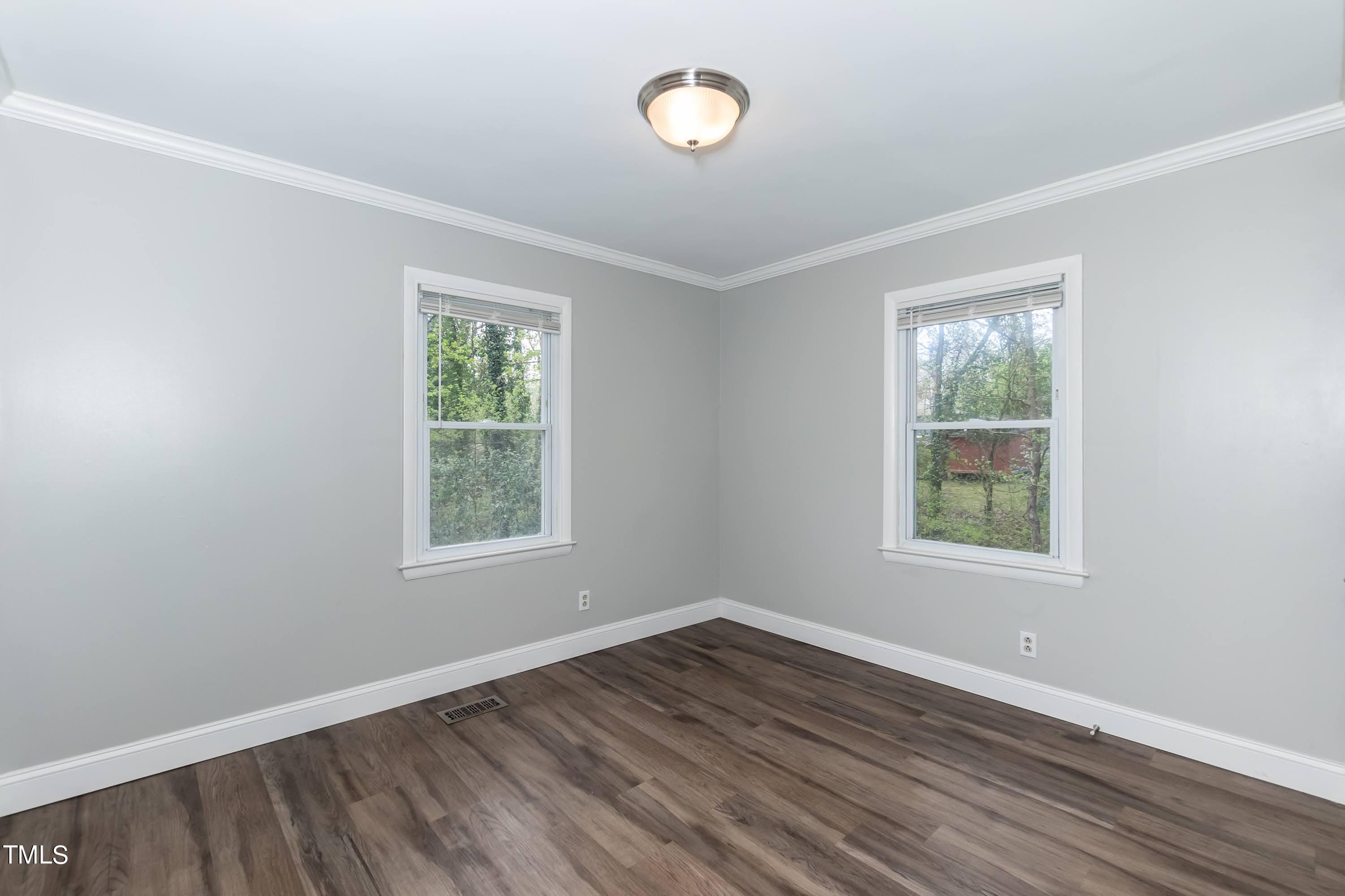 2019 Highway 55 Durham, NC 27707 - Photo 12 of 34 an empty room with wooden floor and windows