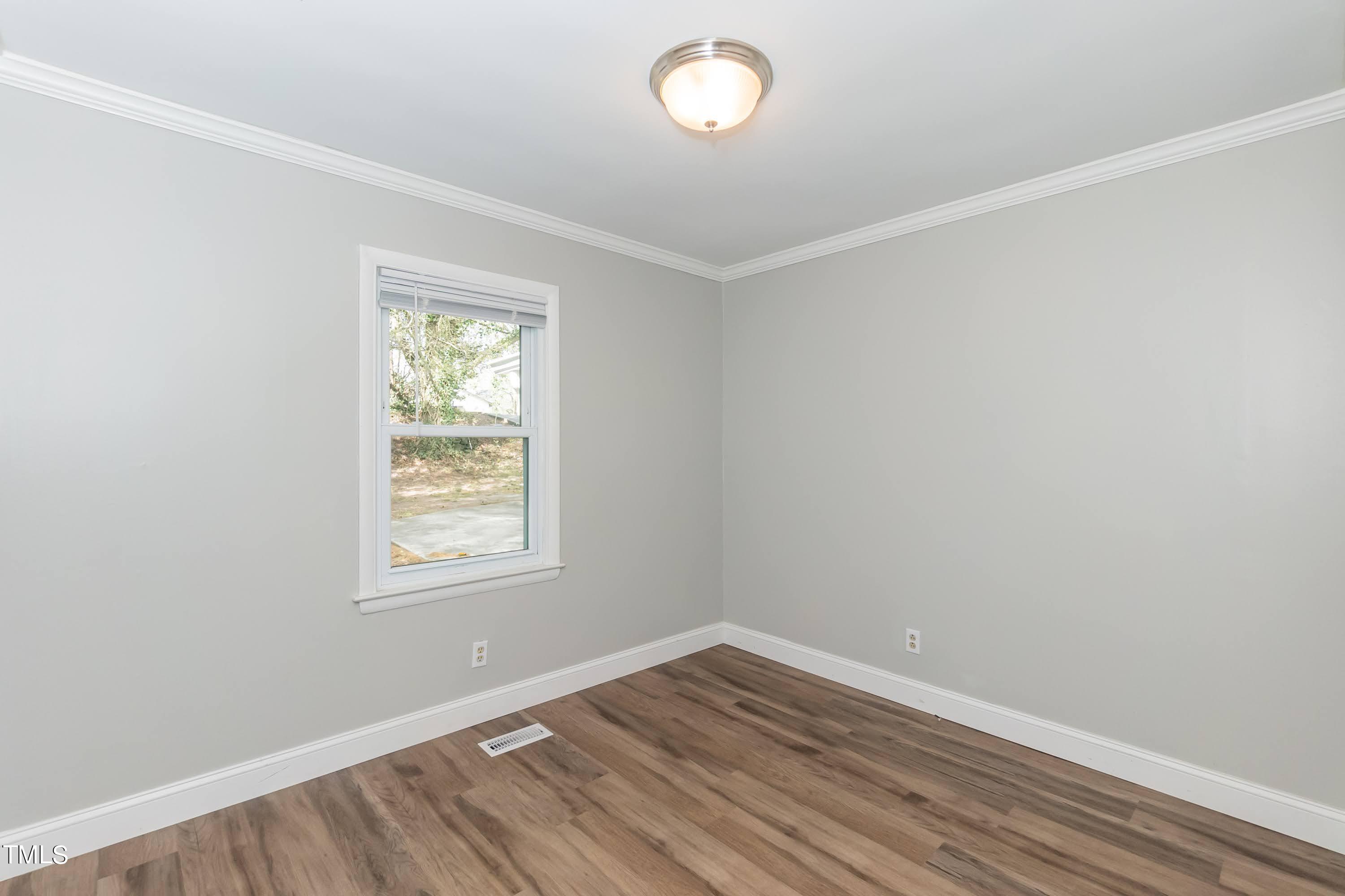 2019 Highway 55 Durham, NC 27707 - Photo 16 of 34 an empty room with wooden floor and windows