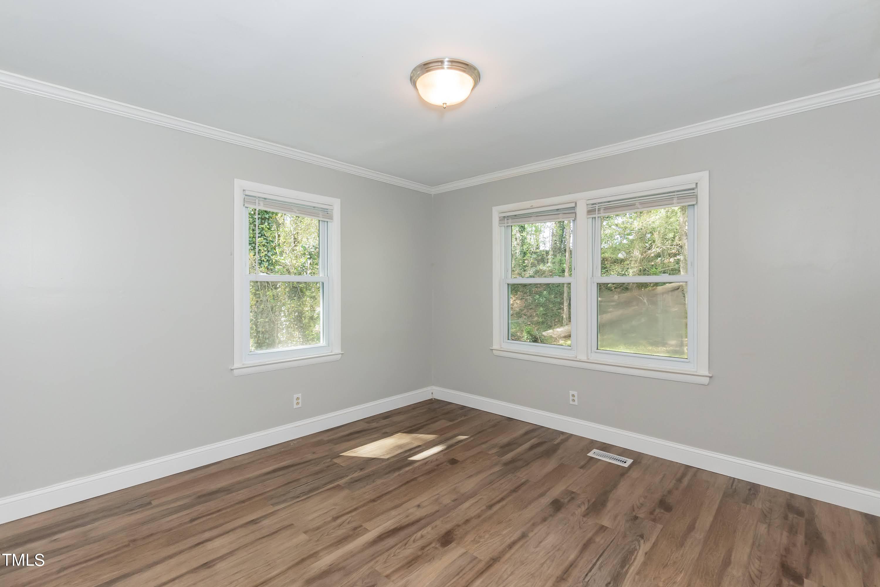 2019 Highway 55 Durham, NC 27707 - Photo 17 of 34 an empty room with wooden floor and windows