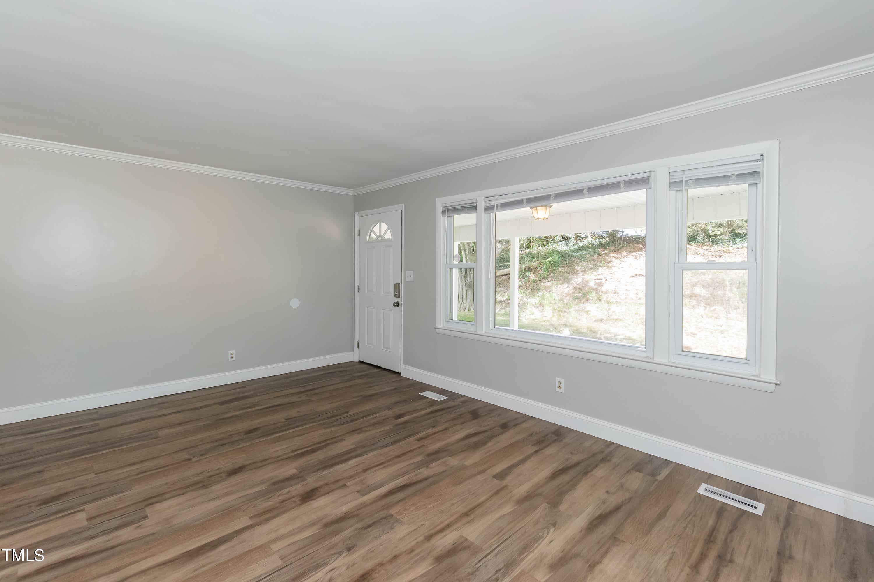 2019 Highway 55 Durham, NC 27707 - Photo 4 of 34 an empty room with wooden floor and windows
