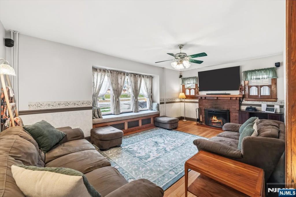 119 Overpeck Avenue Ridgefield Park, NJ 07660 - Photo 4 of 44 a living room with furniture a fireplace and a flat screen tv