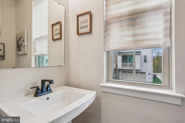 a bathroom with a sink and a window