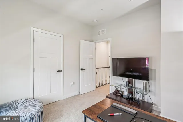a living room with a flat screen tv and a couch
