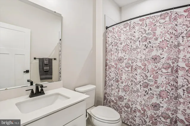 a bathroom with a sink toilet and mirror
