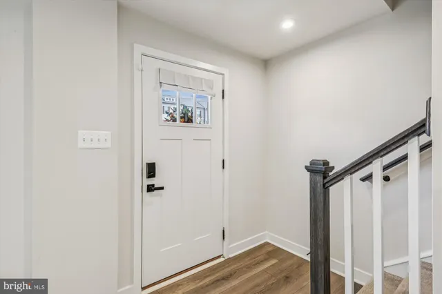 a view of front door with wooden floor