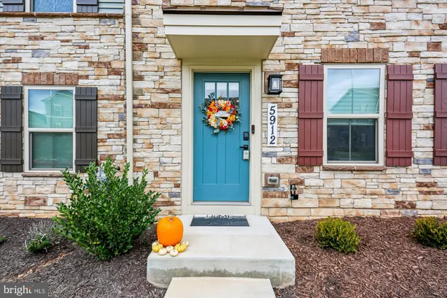 a front view of a house with outdoor seating