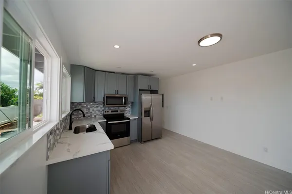 a kitchen with refrigerator and stove