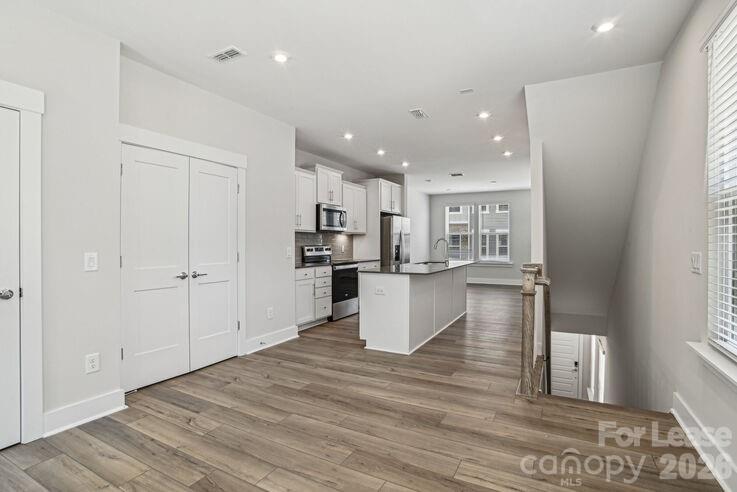 4375 Raleigh Street, Unit C1 Charlotte, NC 28213 - Photo 8 of 19 a view of kitchen and kitchen with hardwood floor