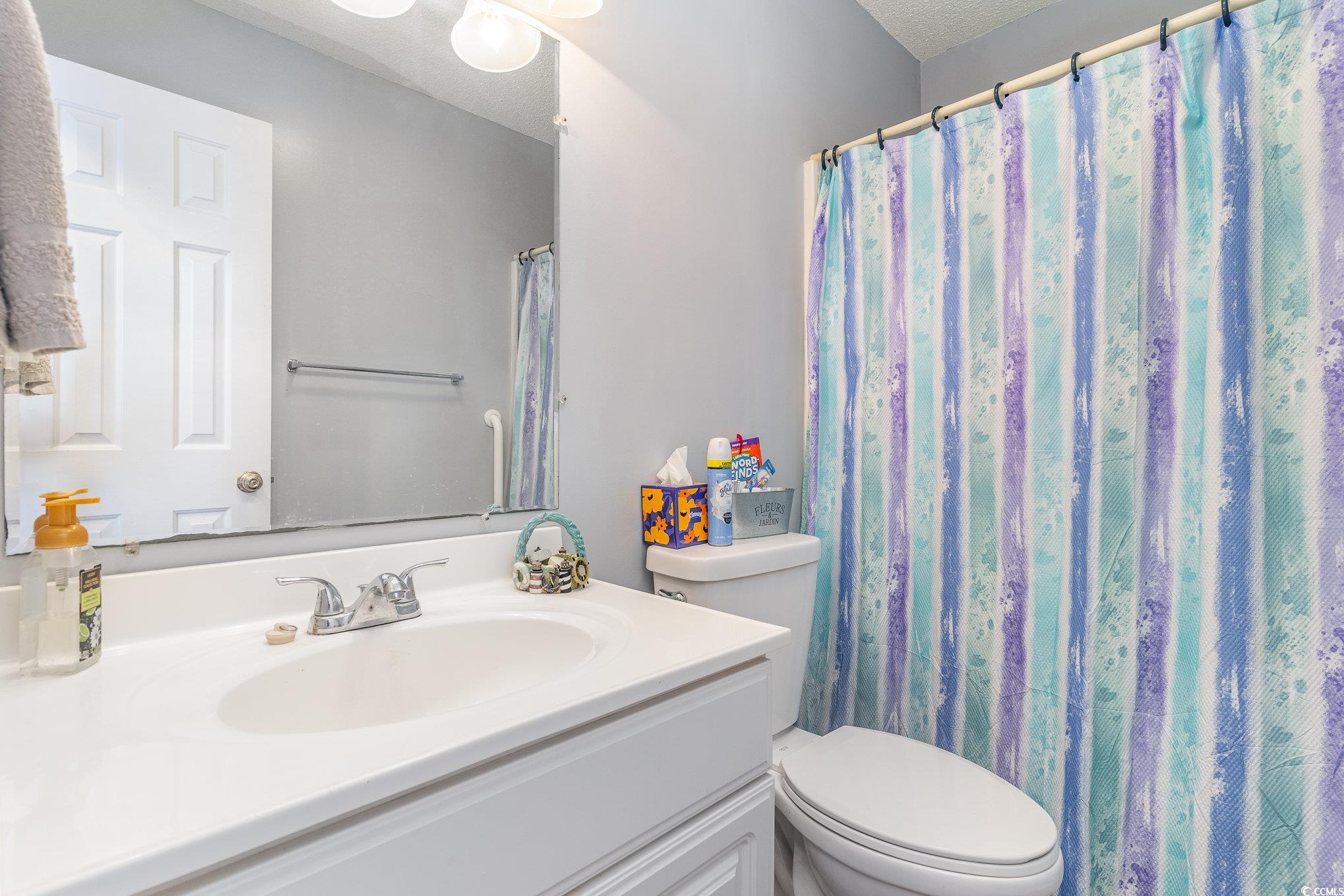 354 Deer Run Avenue Georgetown, SC 29440 - Photo 14 of 32 Bathroom with toilet, a shower with curtain, a tex