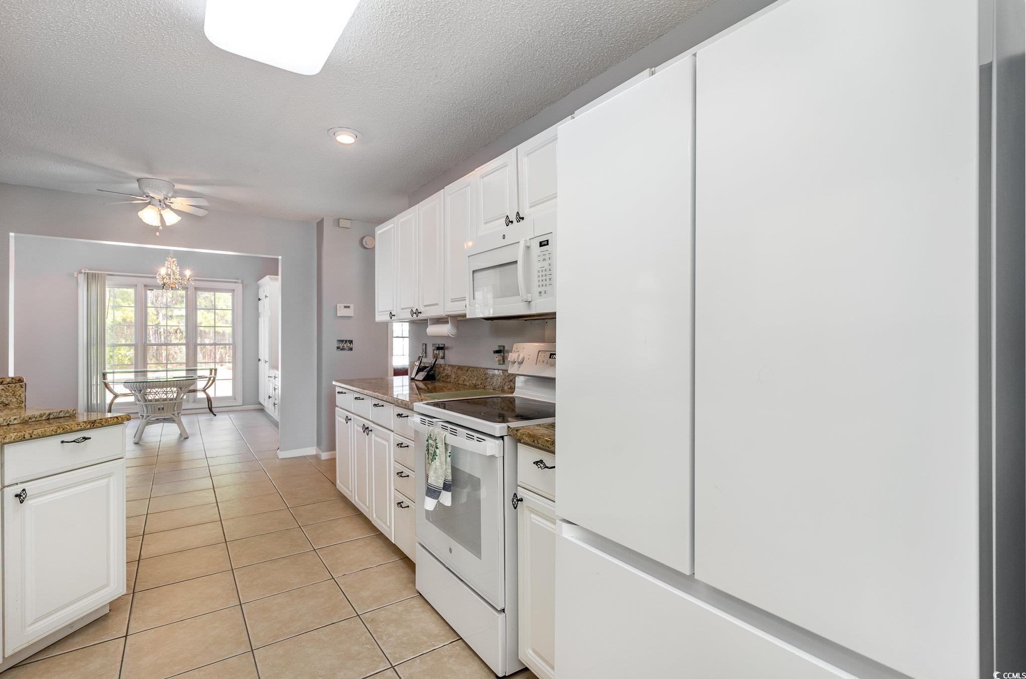354 Deer Run Avenue Georgetown, SC 29440 - Photo 6 of 32 Kitchen featuring white appliances, light tile pat