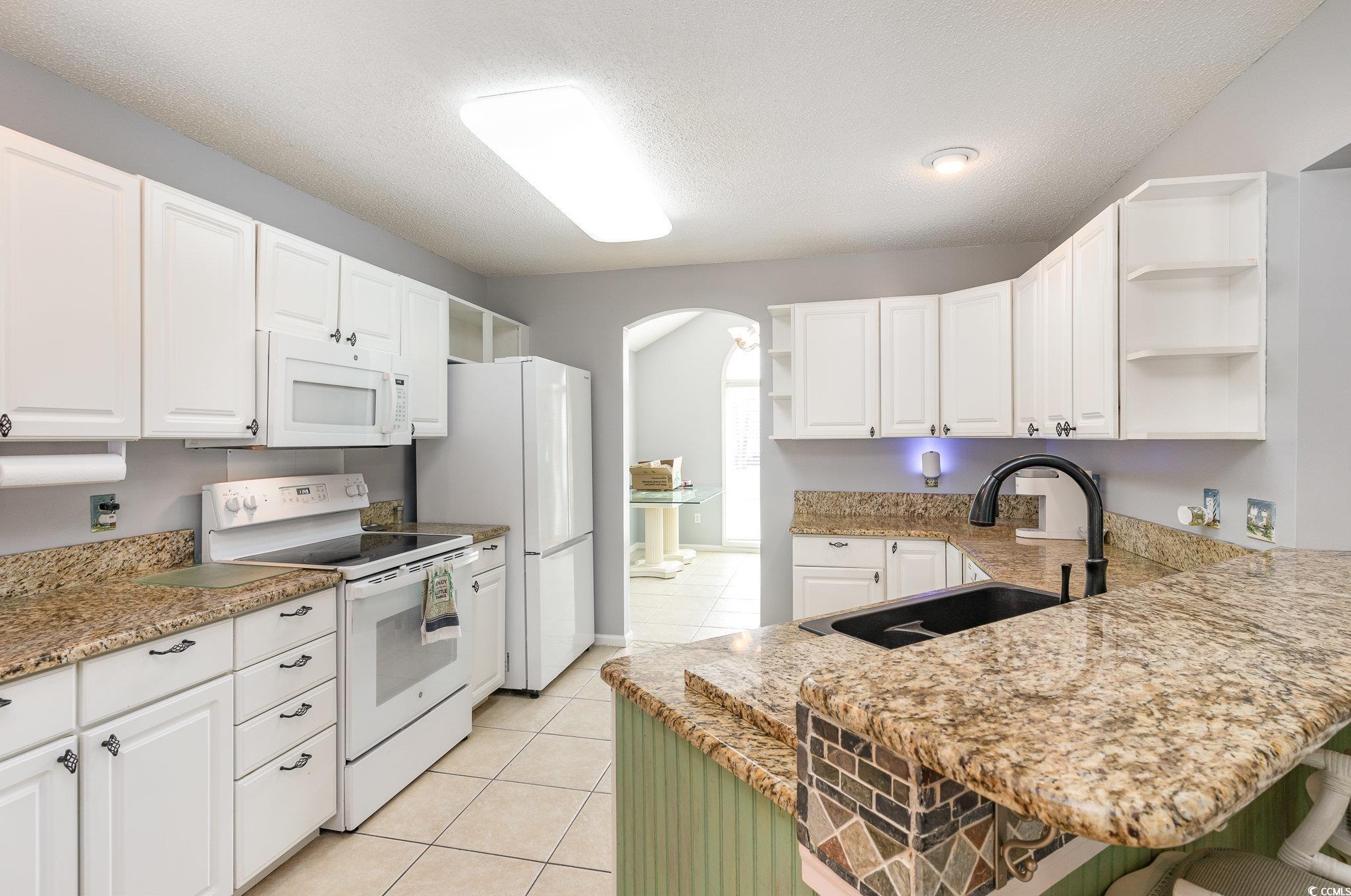354 Deer Run Avenue Georgetown, SC 29440 - Photo 7 of 32 Kitchen featuring light tile patterned floors, ope