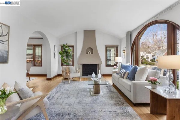 a living room with furniture a fireplace and a potted plant